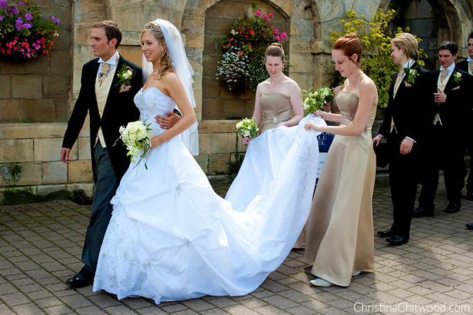 Christina, Tom, Groomsmen, and Bridesmaids Holding Christina's Train