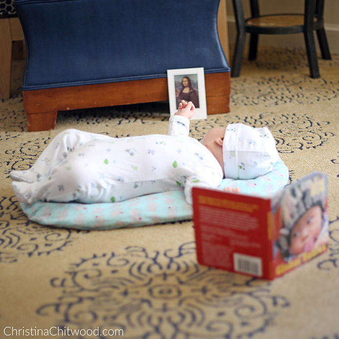 Our Baby Boy Enjoying Concentrating on the Mona Lisa Art Postcard in His Montessori Space on His Second Trip at 2 Months Old