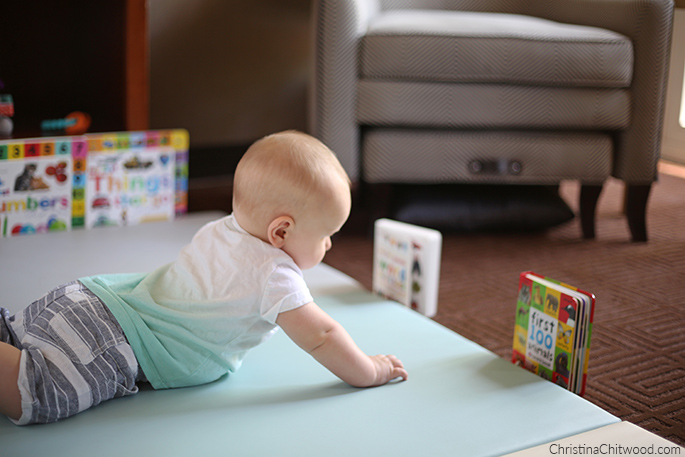Our Baby Boy Studying a Book in His Montessori Space on His Fourth Trip at 5 Months Old
